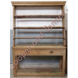 A Victorian pine dresser and plate rack, set with single drawers and three open shelf sections,