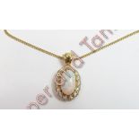 An opal and diamond pendant on chain, the oval cabochon cut opal, approximately 14.5mm by 8.4mm by