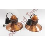 A pair of Louis Poulsen 'Nyhavn' pendant lights in a copper finish