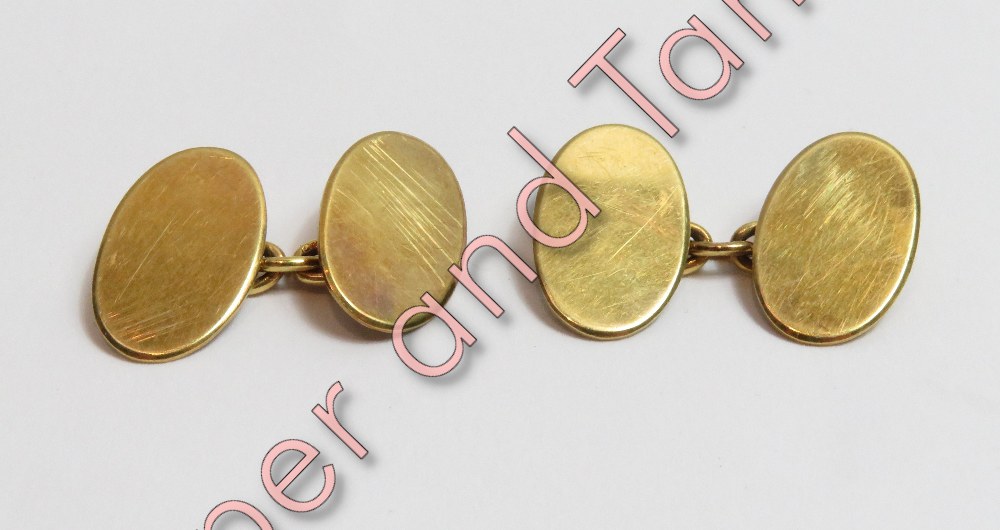 A pair of 18 carat gold cufflinks, the plain oval panels with chain connectors, 8 g gross