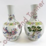 A near pair of Chinese bottle vases, decorated with various figures and animals, 45cm high