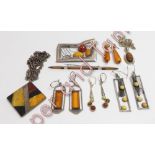 A small collection of amber set jewellery in silver and silver coloured metal
