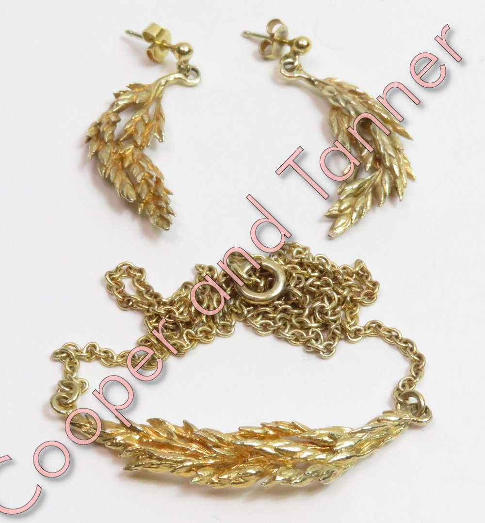 A silver gilt necklace and matching earrings, stamped '925', in the form of a leafy bough