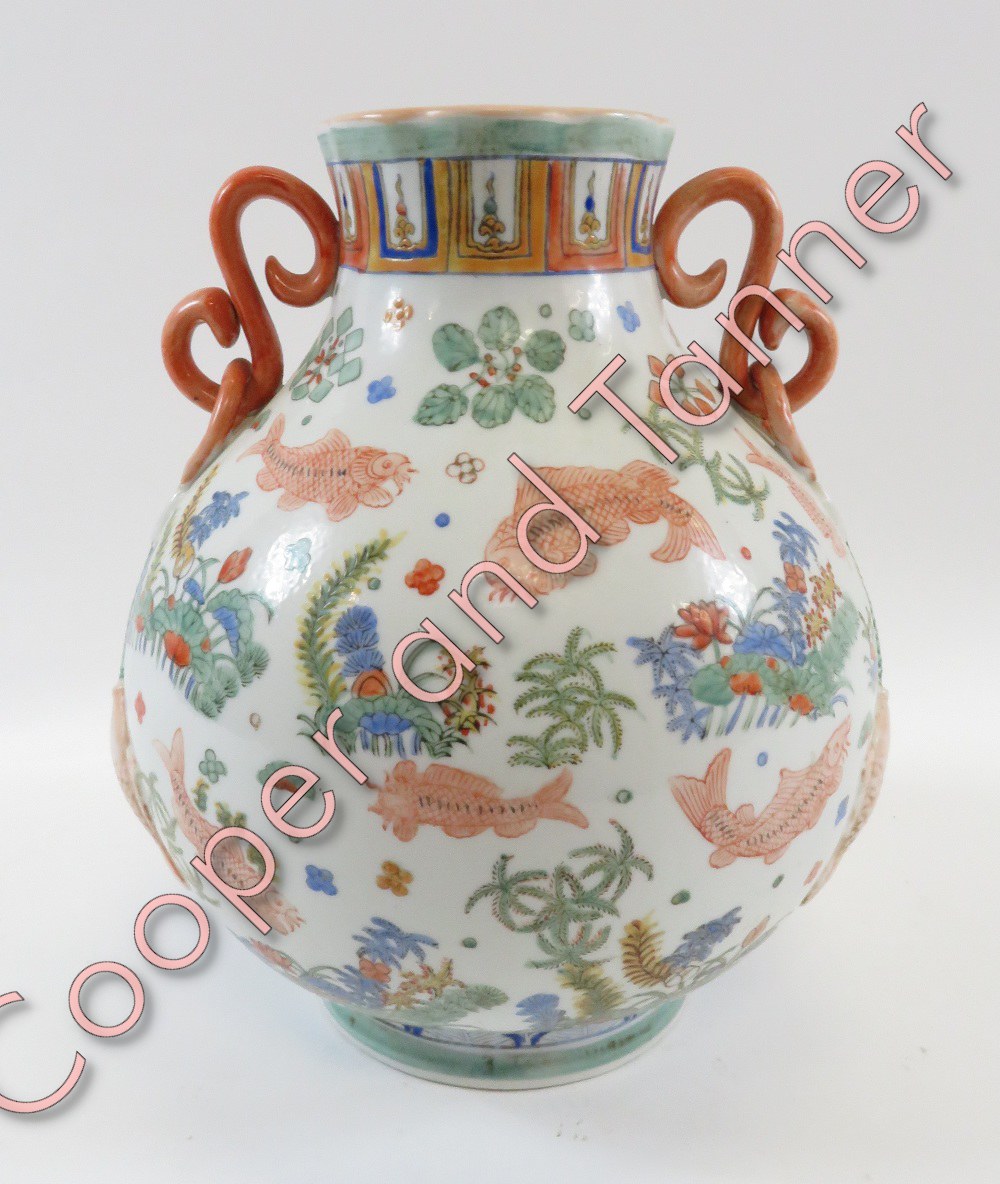 A Chinese two handled bulbous vase decorated with fish amongst various marine plant life, 31cm high