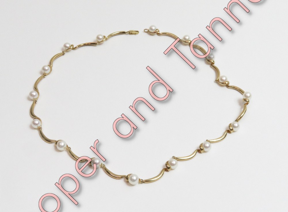 A 9 carat gold necklace, punctuated with sixteen cultured pearls of approximately 5mm each, 41 cm