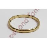 A 9 carat gold bangle of plain D section, inner diameter approximately 6 cm, 11 g gross