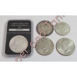 A cased 1889 silver dollar, an 1887 silver dollar, a 1971 dollar, a 1976 dollar and a 'Calgary