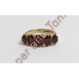 A 9 carat gold five stone garnet ring, finger size N ½, 4.9 g gross