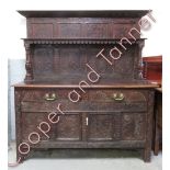 A Victorian carved oak court cupboard, with two drawer and two cupboard section, 183cm high, 163cm