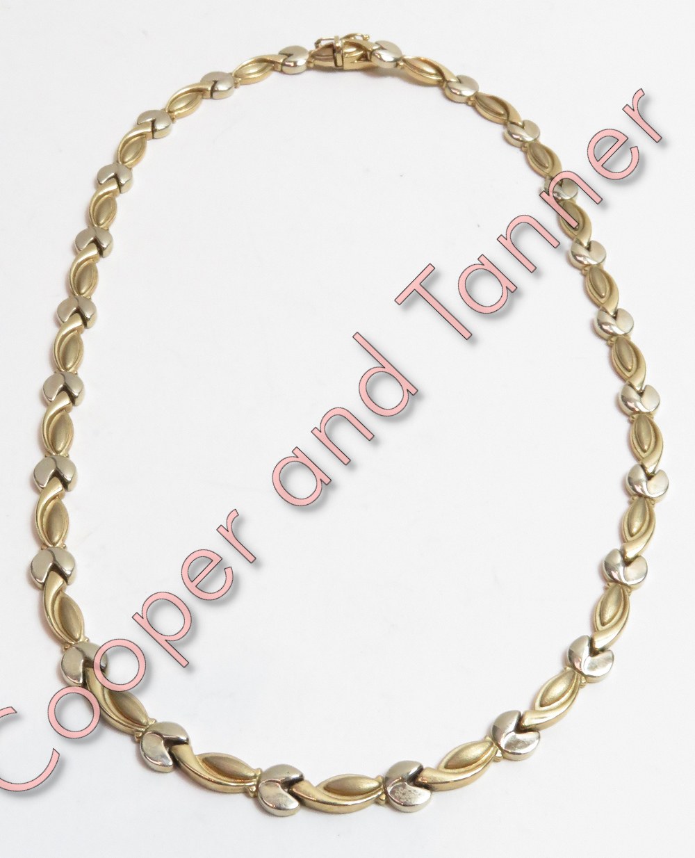 A two colour 9 carat gold collar, with a hidden box clasp and safety catch, 41 cm long, 18.4 g