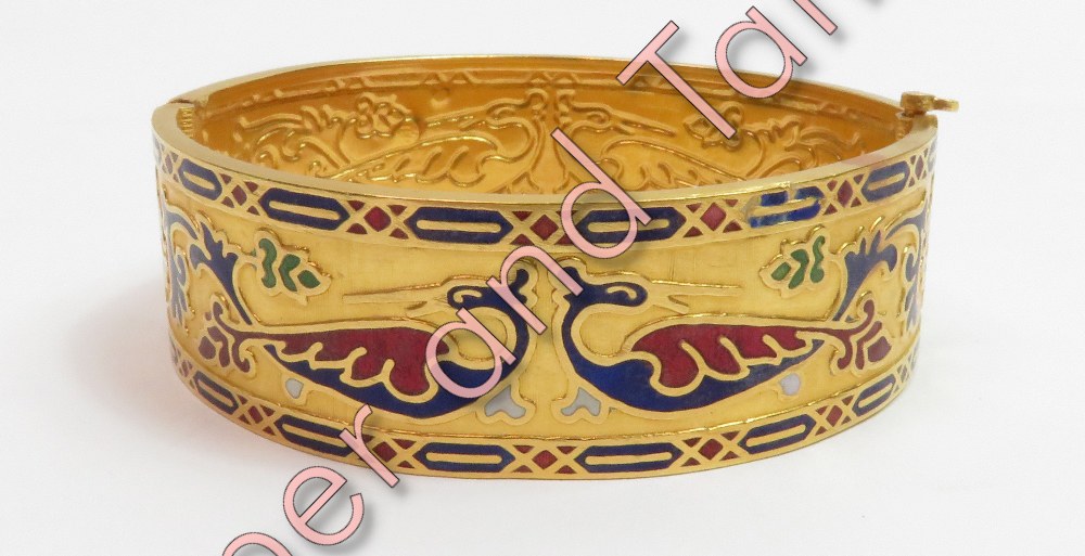 A continental enamelled gold hinged bangle, with control marks, decorated with stylised peacocks,