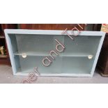 A 1950's dentist wall cabinet, with single glass sliding doors, 51cm high, 91cm long, 29cm deep