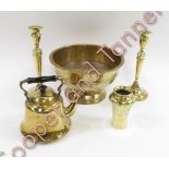 An engraved brass bowl on a circular pedestal base, along with pair of brass candlesticks, brass