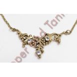 A 9 carat gold necklace, the cast frontispiece set with three stones, to a belcher link back