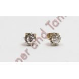 A pair of single stone diamond earstuds, one hallmarked for 18 carat gold, the mirror set