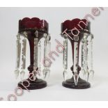 A pair of red Victorian table mantle/lustres and glass drops, raised on circular base, 32cm high