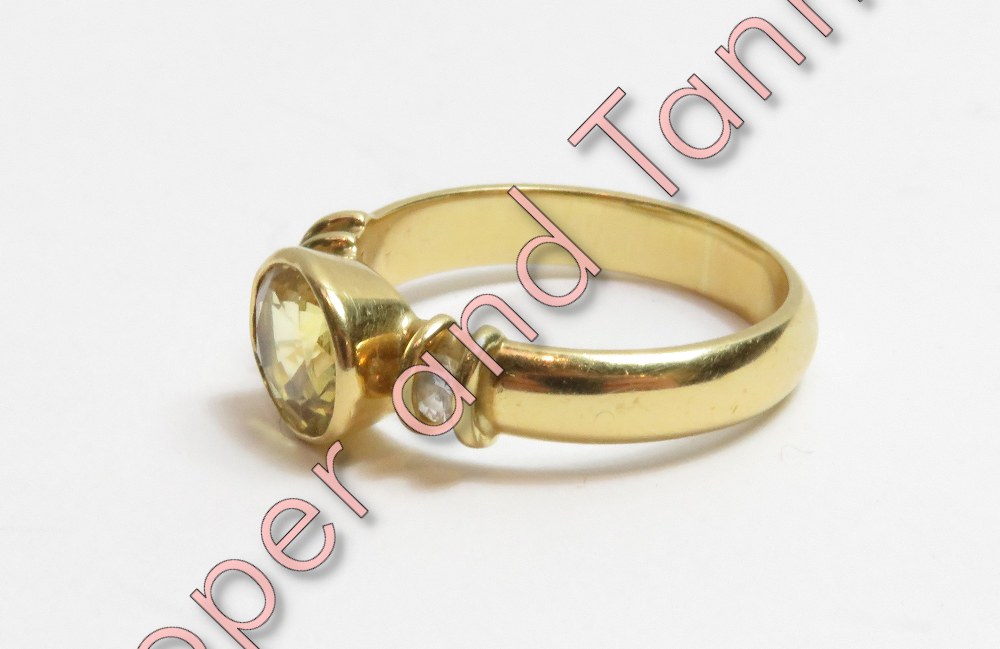 An 18 carat gold yellow sapphire and diamond ring, the oval cut with a diamond to each shoulder, - Image 2 of 3