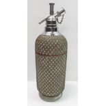 An Art Deco glass and wire mesh soda syphon