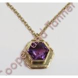 A 9 carat gold amethyst pendant on a 9 carat gold chain, the hexagonal cut stone in a similarly