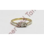 A three stone diamond ring, stamped '18ct', finger size K ½, 2.4 g gross