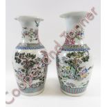 A near pair of decorative Chinese vases, each painted in coloured enamels with various figures, 41cm