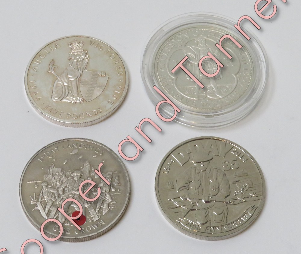 An encapsulated 2009 commemorative £5 coin; a crown and a £5 both celebrating the D-Day landings,