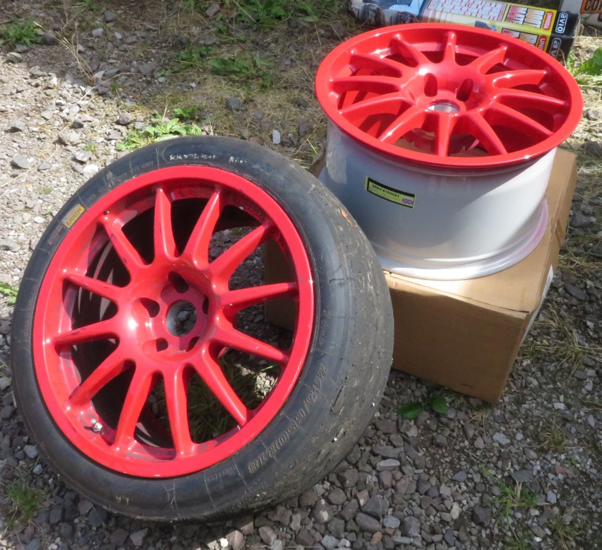 Set of 4 red alloy racing wheels labelled Team Dynamics Pro Race 1.3, 2 with worn tyres in place