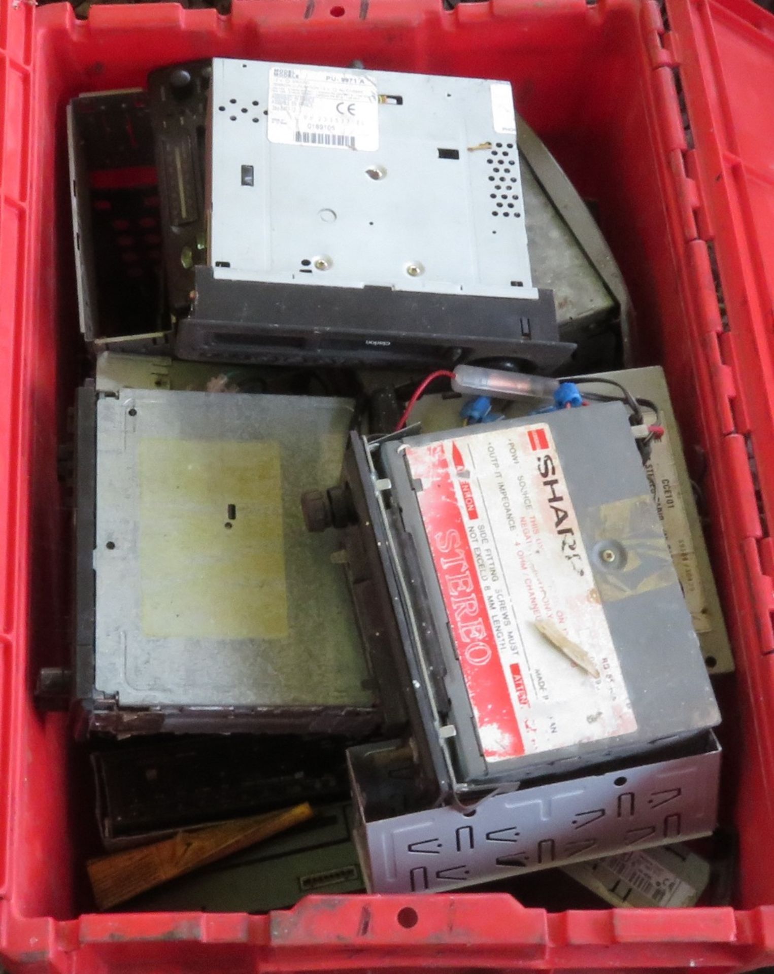 Red box containing various car radios