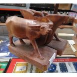 PAIR OF WOODEN BOOKENDS IN THE FORM OF BUFFALO'S