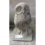 GARDEN STATUE IN THE FORM OF AN OWL SITTING ON A LOG