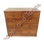 A Victorian stripped pine chest of two short and three long drawers 91cms high 104cms wide