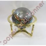 A modern hardstone terrestrial globe, gimble mounted in brass stand approx. 43cms high
