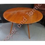 An Ercol oval drop flap dining table 111cms x 120cms extended