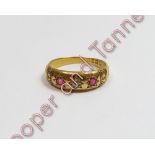 An Edwardian 18 carat gold ruby and diamond three stone ring, London 1903, with carved decoration to