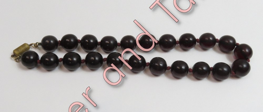 A uniform row of dark amber style beads