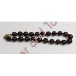 A uniform row of dark amber style beads