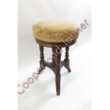 A Victorian circular adjustable piano stool on turned supports