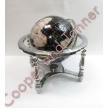 A modern hardstone terrestrial globe, gimble mounted in white metal mount, 32cms high