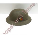 A Belgian green painted metal military helmet with original leather inner and chin strap