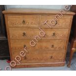 A Victorian pitch pine chest of two short and three long drawers with crossbanded decoration and