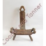 A 19th Century wooden birthing stool having trefoil and heart shaped pierced decoration and on three
