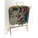 A late Victorian brass and glass fire screen, the glass painted with floral decoration, 64cms high