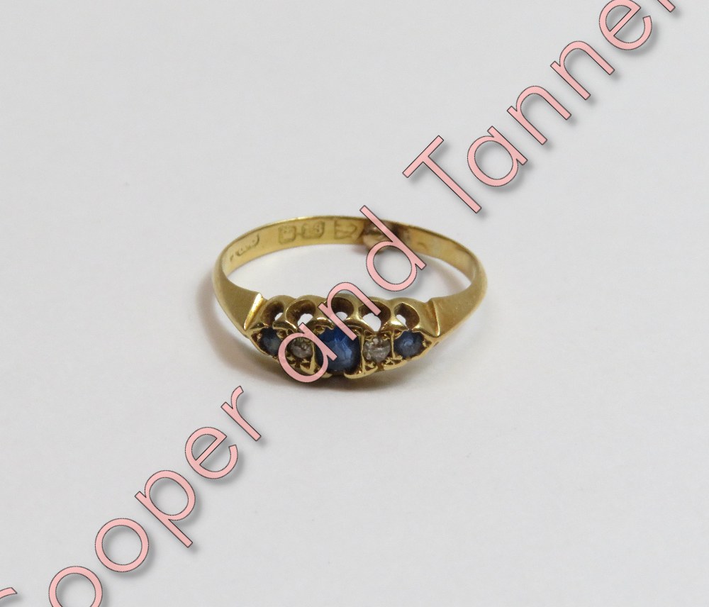 An Edwardian 18 carat gold five stone diamond and sapphire ring, Chester hallmark date letter