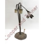 An American cast metal table lamp with decorative flower heads, down turned lamps holders on
