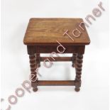 An oak joint stool the rectangular top on four bobbin turned supports and plain stretchers 49cms