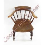A 19th Century bow back Windsor chair with shaped elm seat and initials “GM” stamped to the back