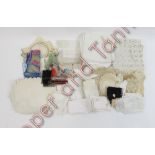 A quantity of assorted white linen table mats, some with crochet borders, damask cloths, embroidered