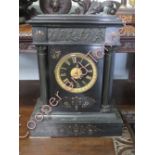 A large French 8 day black slate mantel clock, striking on a gong with pendulum but no key.