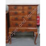 A Queen Ann style walnut chest on stand having two short and three graduated long drawers the base