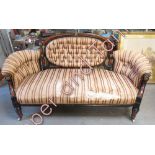 A Victorian settee having ebonised and inlaid walnut frame with gilt mounts, button back and